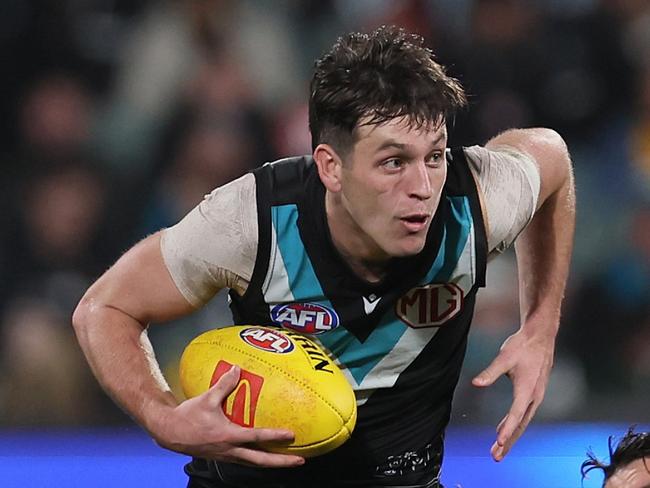 ADELAIDE, AUSTRALIA - JULY 20: Dion Prestia of the Tigers tries to tackle Zak Butters of the Power during the 2024 AFL Round 19 match between the Port Adelaide Power and the Richmond Tigers at Adelaide Oval on July 20, 2024 in Adelaide, Australia. (Photo by James Elsby/AFL Photos via Getty Images)