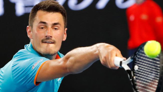 Bernard Tomic hits a return in his loss to Marin Cilic last night. Picture: AFP