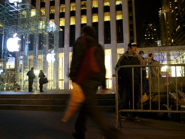 <p>Greg Packer, of Huntington NY, right, holds his place as first in line outside the Fifth Avenue store since Tuesday at 7am for the release of Apple's iPad on April 2, 2010. Picture: David Goldman/Getty Images/AFP</p>