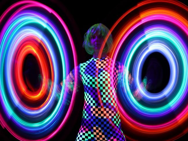 Long exposure photos of a woman and a light stick, captured with a Canon EOS 80D inside the camera maker's Vivid Sydney workshop held by Graham Monro.