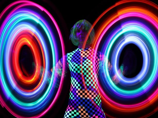 Long exposure photos of a woman and a light stick, captured with a Canon EOS 80D inside the camera maker's Vivid Sydney workshop held by Graham Monro.