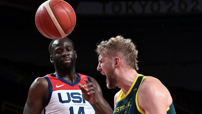 Australia's Jock Landale, right, and USA’s Draymond Jamal Green in the first half. Picture: Aris Messinis/AFP