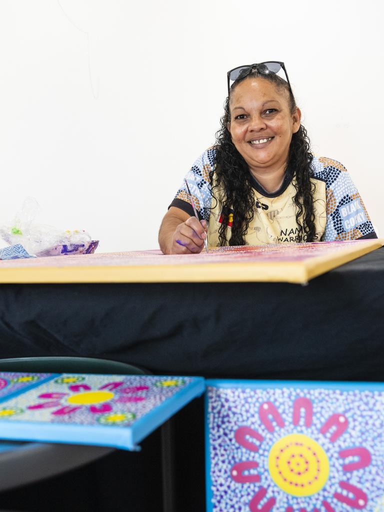 Stacey Trindall of Baru Maranga Art works on a piece of art at her stall at the Indigenous Artisan Markets at The Lighthouse, Saturday, December 17, 2022.