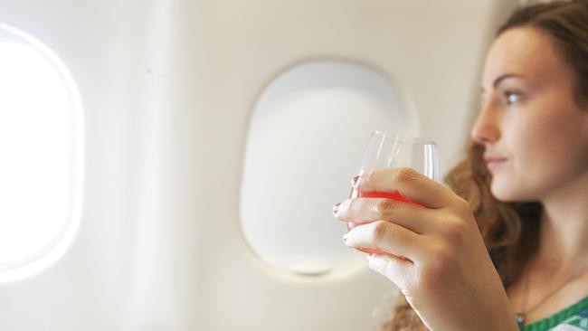 ESCAPE: A young woman enjoying a drink during flight - destination vacation. Picture: Istock