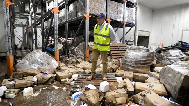 Prime Minister Scott Morrison inspects flood damage at the Norco Ice Cream Factory in Lismore. (AAP Image/Dave Hunt)