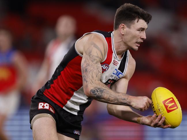 MELBOURNE, AUSTRALIA - AUGUST 04:  Josh Battle of the Saints handballs during the round 21 AFL match between St Kilda Saints and Brisbane Lions at Marvel Stadium, on August 04, 2024, in Melbourne, Australia. (Photo by Darrian Traynor/Getty Images)