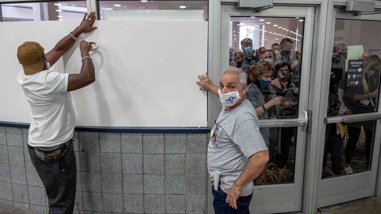 Poll workers board up windows so ballot challengers can't see into the counting area at the TCF Center as ballots are counted in downtown Detroit, Michigan on November 4. Picture: Seth Herald/AFP