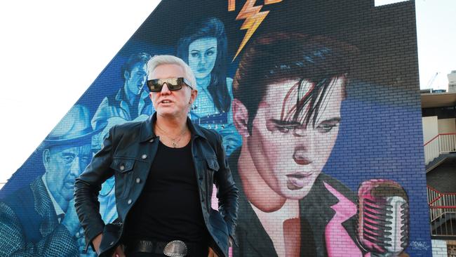 Film Director Baz Luhrmann poses for a photo in front of the giant Elvis Presley TCB mural at Burleigh Heads. Picture: Scott Powick