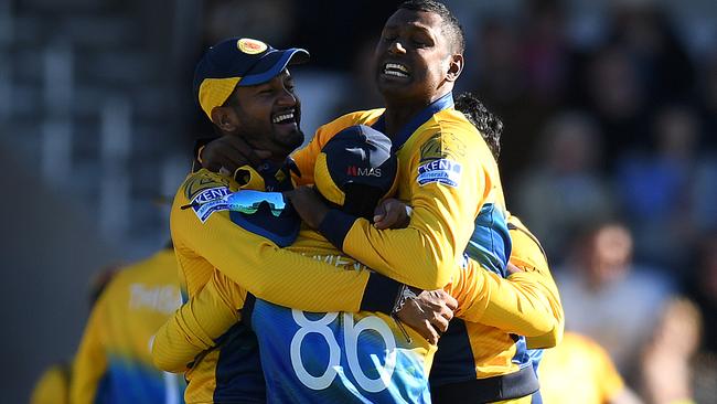 Sri Lanka celebrate their big win.