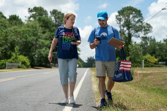 Democratic Party activists Sarah Hardy (L) and Yampiere Lugo (R) canvass voters in Laurinburg, North Carolina