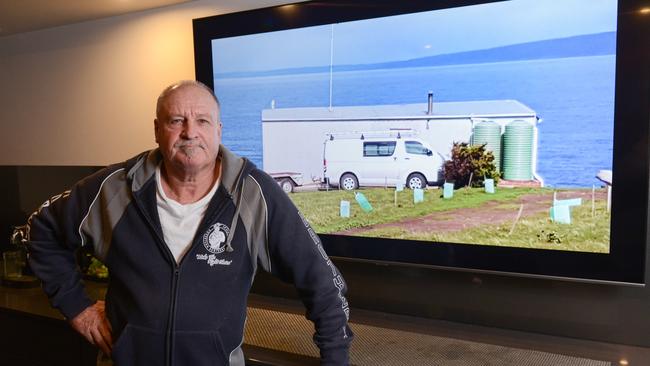 Barry Robertson with a picture of his shack at Deep Creek. Picture: Brenton Edwards