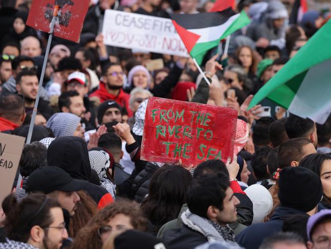 BERLIN, GERMANY - NOVEMBER 04: People, including one holding up a sign that reads: "From the River to the Sea", chant slogans under Palestinian flags during a "Freedom for Palestine" protest that drew thousands of participants on November 04, 2023 in Berlin, Germany. Meanwhile in Gaza Israeli forces have encircled Gaza City as fighting with Hamas fighters continues to rage. (Photo by Sean Gallup/Getty Images)