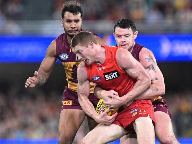 BRISBANE, AUSTRALIA – MAY 04: Matt Rowell of the Suns is pressured by the defence of Lachie Neale of the Lions during the round eight AFL match between Brisbane Lions and Gold Coast Suns at The Gabba, on May 04, 2025, in Brisbane, Australia. (Photo by Bradley Kanaris/Getty Images)