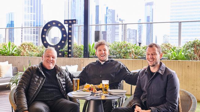 Dylan Alcott (centre) with dad Martin and brother Zack sample Man Tea’s Father’s Day offering on the Rooftop at QT Melbourne. Picture: Marten Ascenzo