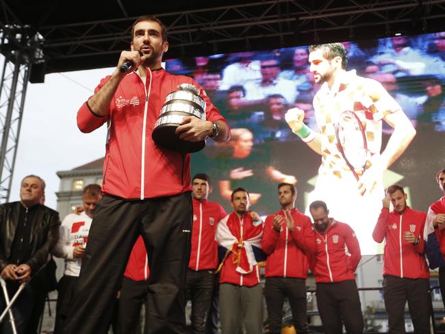 Marin Cilic holds the trophy as he addresses the crowd with his teammates of Croatia's Davis Cup, welcomed by thousands at the central square in Zagreb, Croatia, Monday, Nov. 26, 2018. Croatia defeated France and claimed a second title in the team event following its maiden win in 2005. (AP Photo/Darko Bandic)