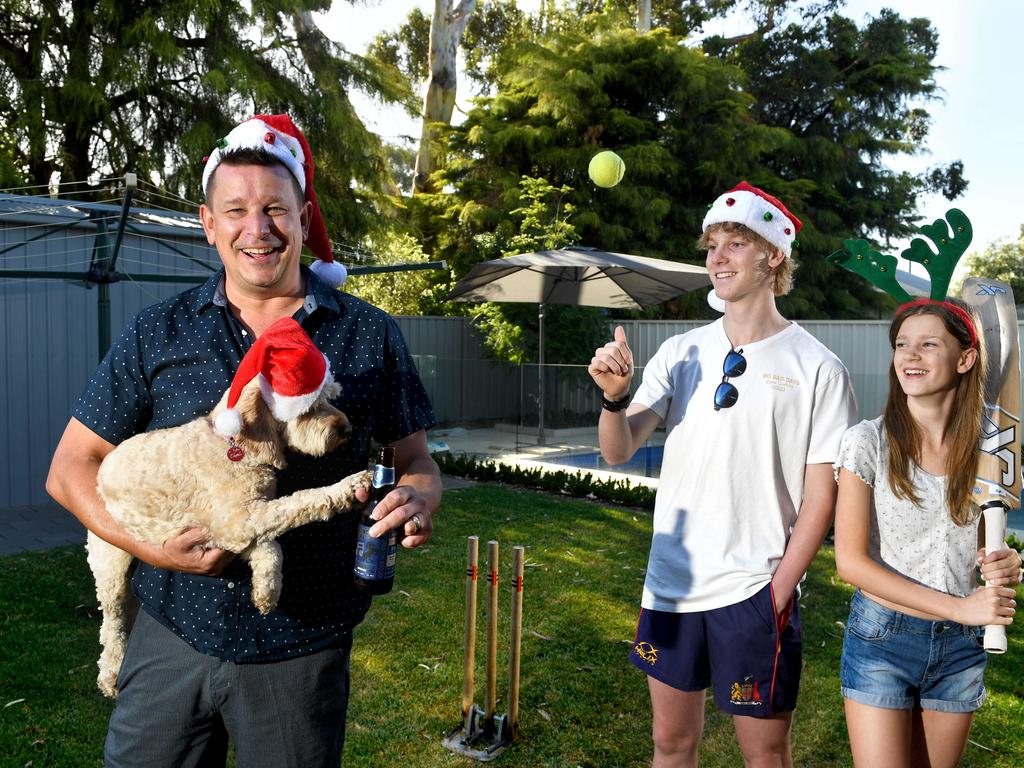 Brett Atkinson with kids Erin 13 and Brady 15 and dog Charli in their backyard. Picture: Tricia Watkinson