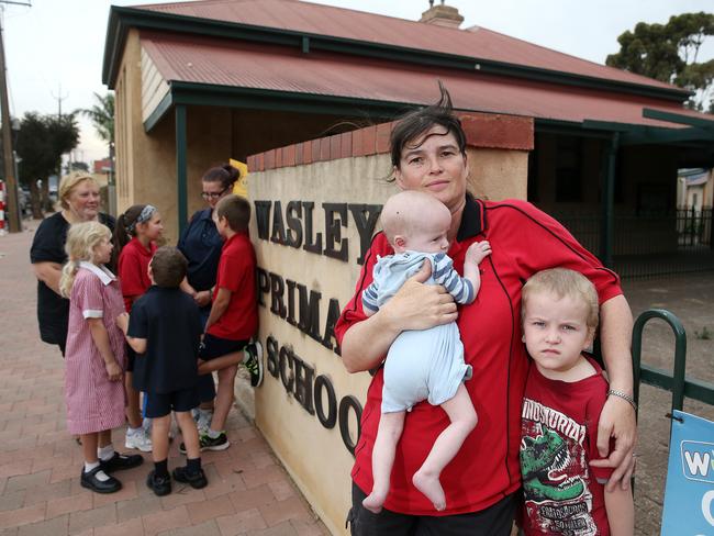 Jenny Polley with her baby Kelvin and son Fred and other locals at the Wasleys Primary School, where they took shelter as the firefront passed. Picture: Calum Robertson