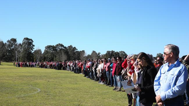 A guard of honour is formed by the family, friends and community of Singleton as the funeral cars depart the park for the final two victims of the Hunter Valley wedding bus crash who will be laid to rest in a funeral in Singleton. Picture: NCA NewsWIRE / Gaye Gerard