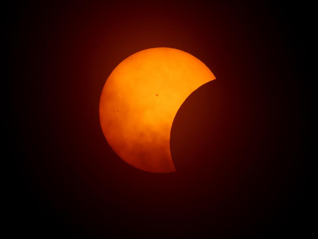 The moon begins to eclipse the sun on April 8, 2024 in Fort Worth, Texas. Millions of people have flocked to areas across North America that are in the "path of totality". Picture: AFP