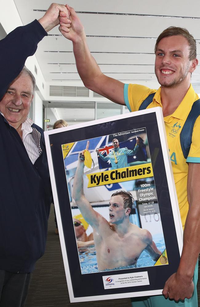 Chalmers is presented with<i> The Advertiser’s </i>souvenir poster of his win upon his arrival home. Picture: Sarah Reed