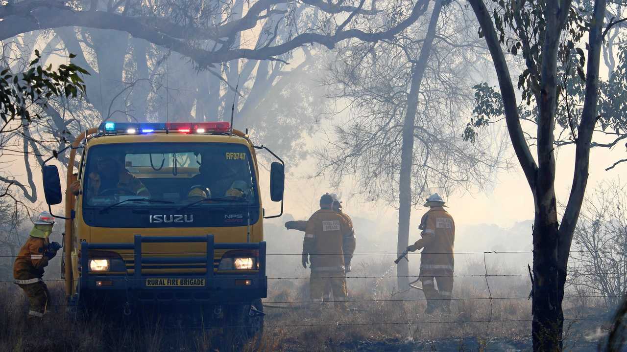 HARD WORK: Fire fighers were up against winds of 60km/h on Sunday afternoon. Picture: Liana Walker