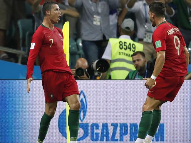 Portugal's forward Cristiano Ronaldo (L) celebrates his third goal during the Russia 2018 World Cup Group B football match between Portugal and Spain at the Fisht Stadium in Sochi on June 15, 2018. / AFP PHOTO / Odd ANDERSEN / RESTRICTED TO EDITORIAL USE - NO MOBILE PUSH ALERTS/DOWNLOADS