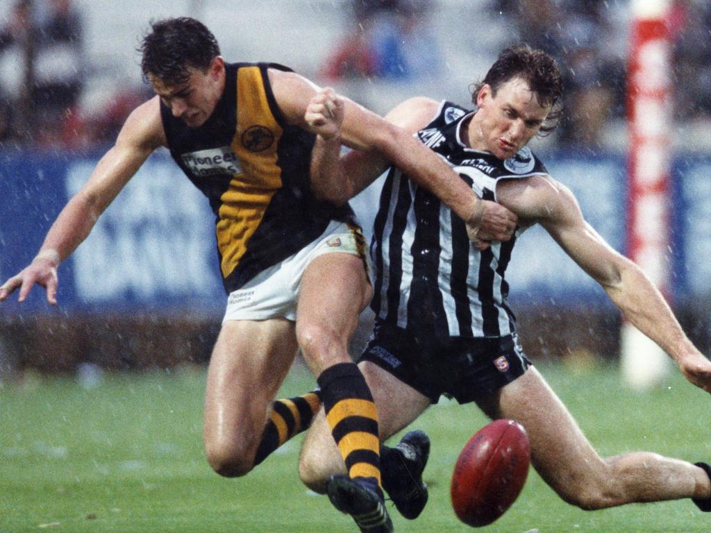 Scott Hodges and Paul Rouvray slide across the turf as they attempt to win the ball in 1992. Picture: Nicholas Wilson