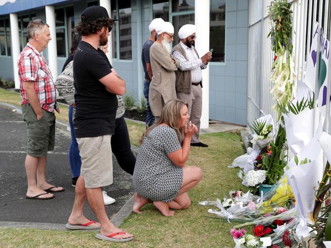 People gather at the entrance to the Port of Tauranga where the Ovation of the Seas is berthed in Tauranga, New Zealand. Picture: David Rowland