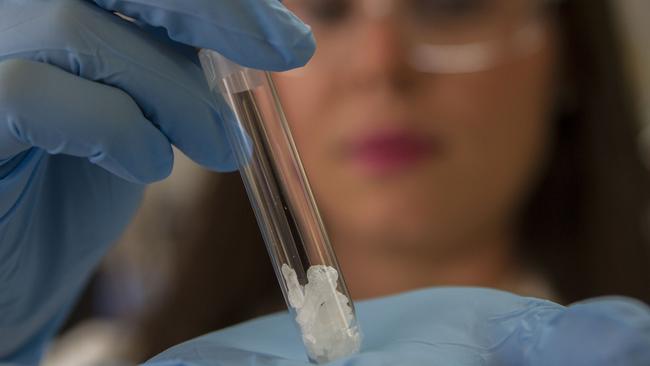 A forensic officer tests ecstasy pills at the Victoria Police Forensic Services Centre. Picture: Richard Serong