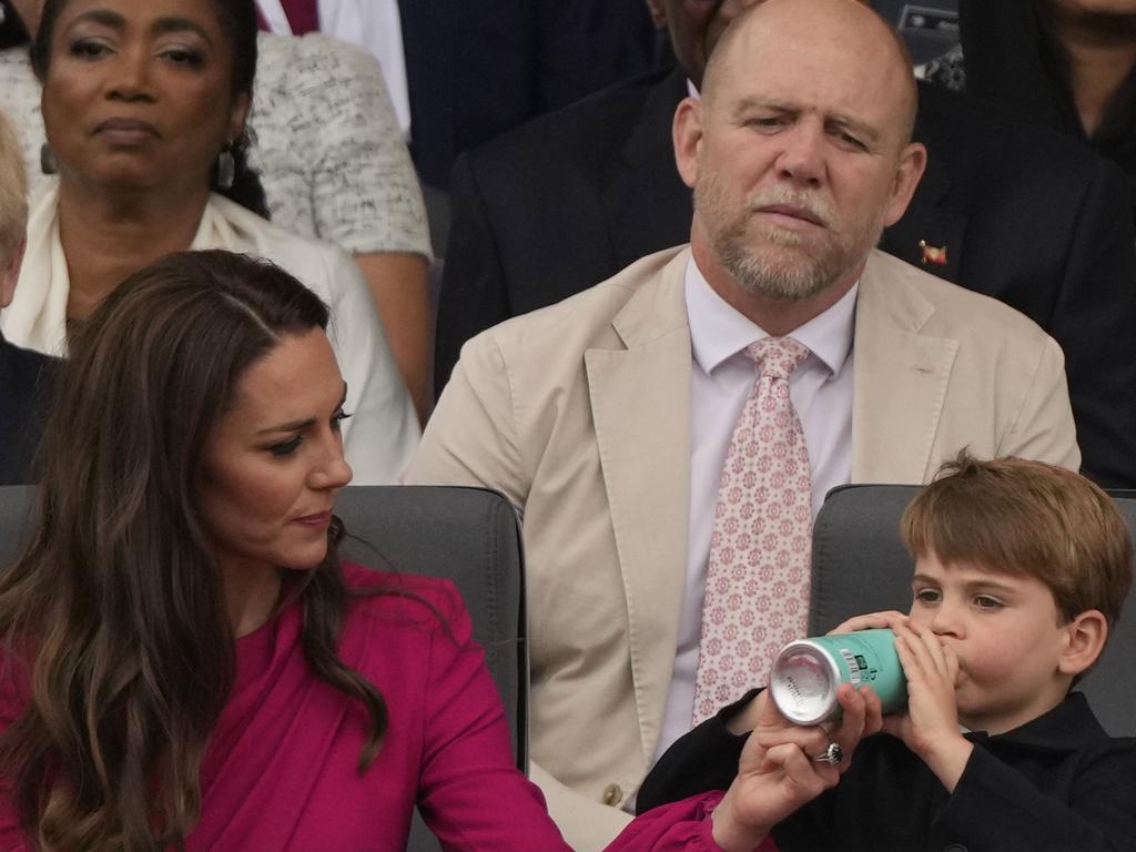 Mike Tindall watches over Prince Louis as he takes a drink. Picture: Getty Images