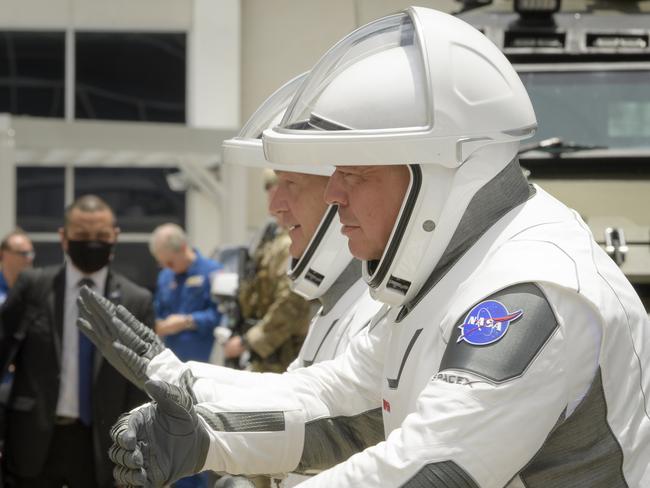 NASA astronauts Douglas Hurley, left, and Robert Behnken, wearing SpaceX spacesuits, give their families virtual hugs before boarding the space craft. Picture: AP