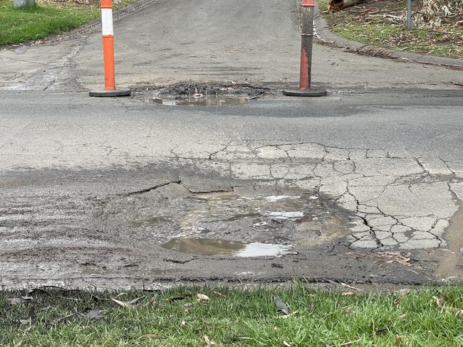 Fresh potholes that sink deeper when driven over have appeared in Coburn Ave above the McCrae landslide hot zone. Picture: Lucy Callander