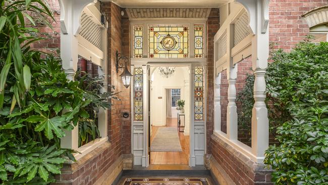 Stained glass, marble fireplaces, arched hallways and ceiling roses feature throughout.