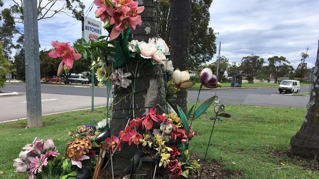 A makeshift memorial at the scene of the incident at a Nambucca shopping centre car park.