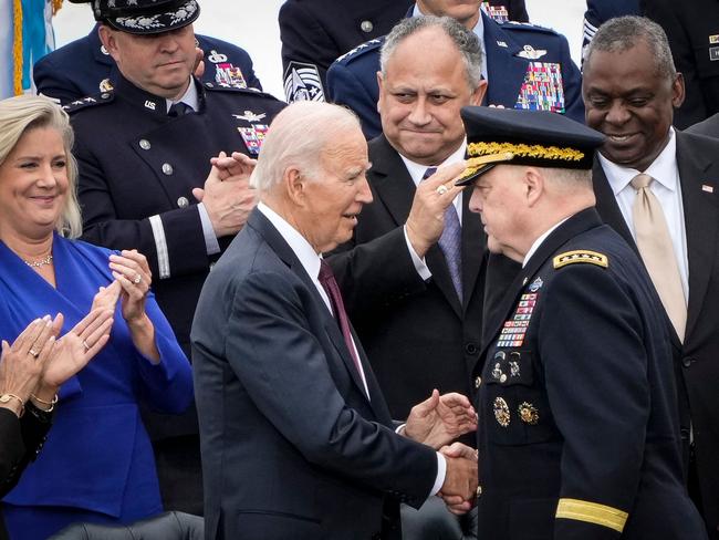 Former US President Joe Biden shakes hands with outgoing Chairman of the Joint Chiefs of Staff General Mark Milley after Milley spoke during an Armed Forces Farewell Tribute in his honour in 2023. Picture: Getty Images