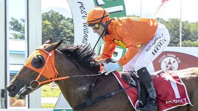 Townsville jockey Aidan Holt pilots North Queensland Cups champion The Harrovian to a monumental victory at Cairns' Cannon Park despite carrying a whopping 67kg. Picture: Mike Mills.