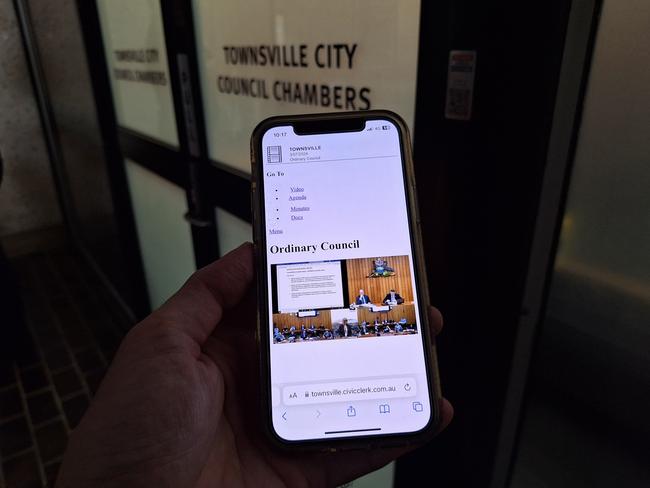 Townsville Bulletin council reporter Chris Burns watching the council livestream on his phone while locked out of the meeting with all other media by returned mayor Troy Thompson.