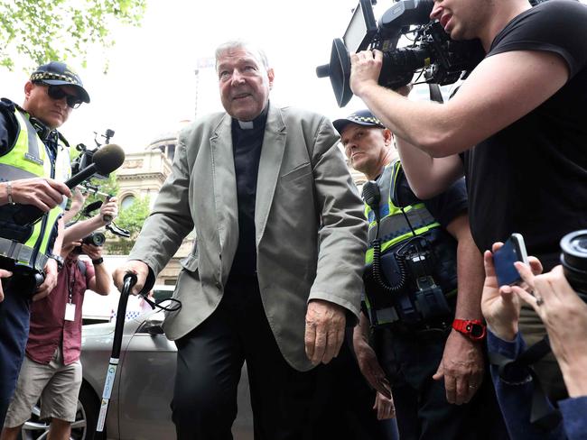 TOPSHOT - Cardinal George Pell (C) walks from a car in Melbourne on February 26, 2019. - Pell is facing prosecution for historical child sexual offences. (Photo by Asanka Brendon Ratnayake / AFP)