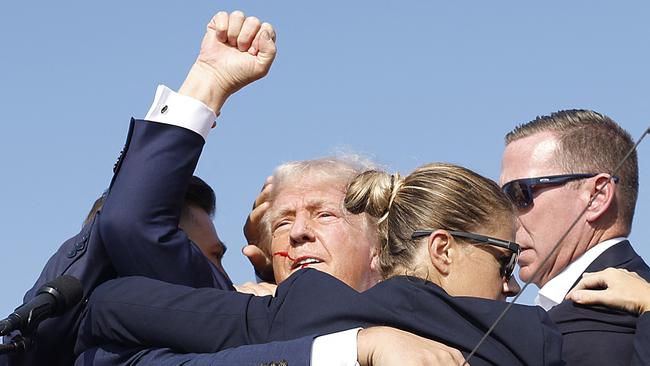 Republican presidential candidate former President Donald Trump is rushed offstage after being grazed by a bullet during a rally in Butler, Pennsylvania.