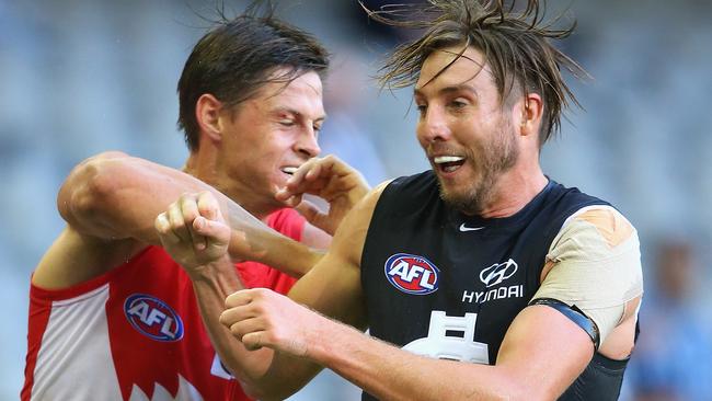 MELBOURNE, AUSTRALIA - MARCH 11: Callum Sinclair of the Swans and Dale Thomas of the Blues bump each other during the NAB Challenge AFL match between the Carlton Blues and the Sydney Swans at Etihad Stadium on March 11, 2016 in Melbourne, Australia. (Photo by Quinn Rooney/Getty Images)