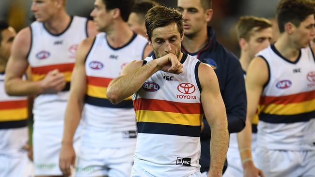 Richard Douglas leads Adelaide from the ground after the round loss to Hawthorn at the MCG. Picture: AAP Image/Julian Smith.