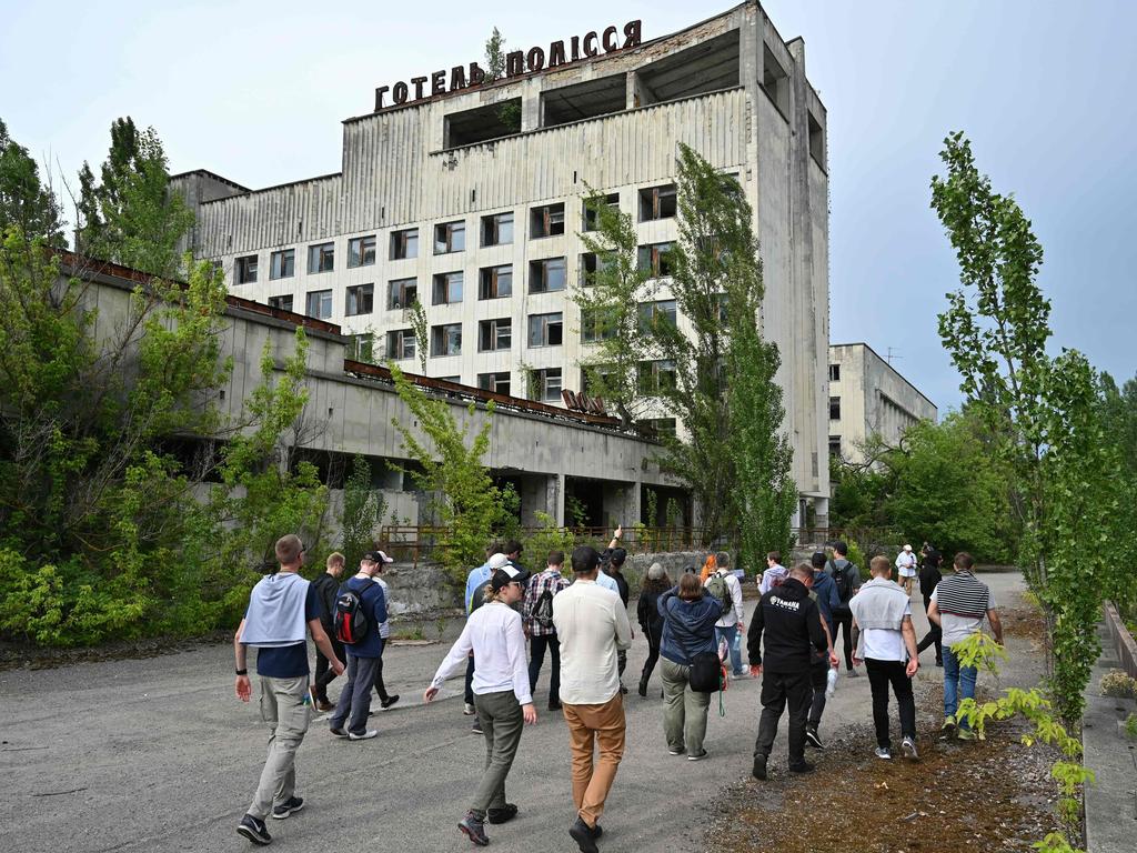 Visitors walk in Pripyat during a tour of the Chernobyl exclusion zone. Picture: Genya Savilov/AFP