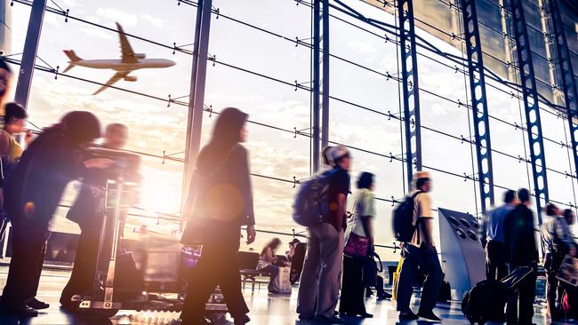 Passengers at a busy international airport.