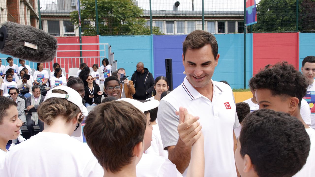 Federer greets tennis juniors during UNIQLO's Around The World With Roger Federer event in La Courneuve, France. (Photo by Julien M. Hekimian/Getty Images for Uniqlo)