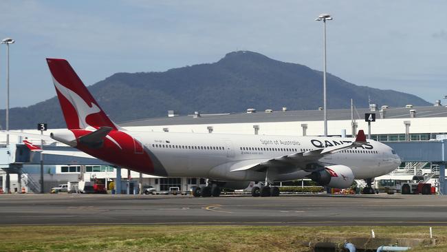 A Qantas Airbus A330 aircraft sits on the tarmac at the Cairns Airport international terminal. Picture: Brendan Radke