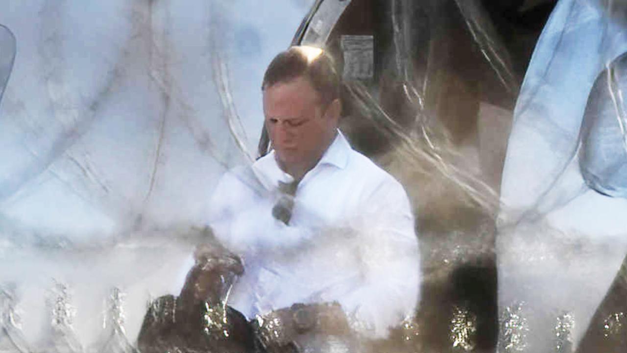 Premier Steven Miles and staff exit a private jet, VH-VKX, at the Government Air Wing, Brisbane Airport. Picture: Lyndon Mechielsen/Courier Mail