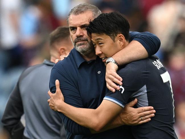 Tottenham Hotspur's Greek-Australian Head Coach Ange Postecoglou (L) embraces Tottenham Hotspur's South Korean striker #07 Son Heung-Min (R) on the pitch after the English Premier League football match between Burnley and Tottenham Hotspur at Turf Moor in Burnley, north-west England on September 2, 2023. Tottenham won the game 5-2. (Photo by Paul ELLIS / AFP) / RESTRICTED TO EDITORIAL USE. No use with unauthorized audio, video, data, fixture lists, club/league logos or 'live' services. Online in-match use limited to 120 images. An additional 40 images may be used in extra time. No video emulation. Social media in-match use limited to 120 images. An additional 40 images may be used in extra time. No use in betting publications, games or single club/league/player publications. /