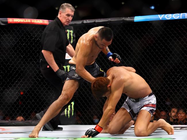 Josh Culibao (L) of Australia knocks down Seungwoo Choi of South Korea in their featherweight bout during UFC 275. Picture: Yong Teck Lim/Getty Images