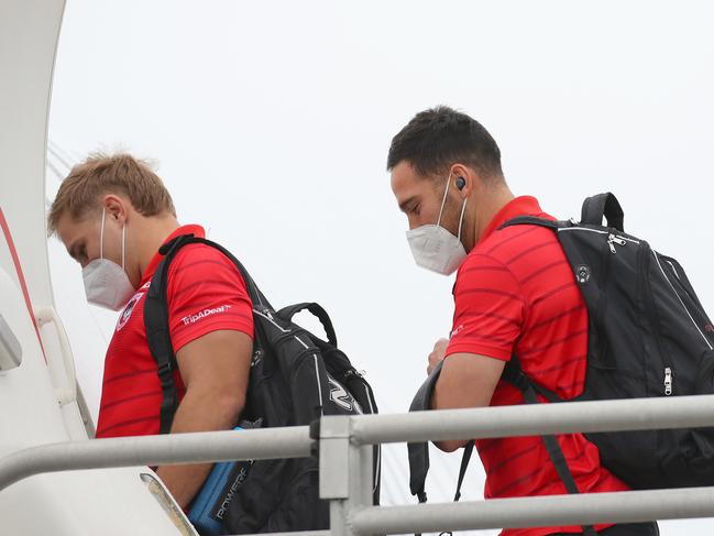 NRL teams depart Sydney via Jet Aviation at Mascot to the hub in Queensland due to the Covid 19 outbreak and lockdown in Sydney. Teams will enter a bubble on the Gold Coast and Sunshine Coast to keep the competition going. The Dragons squad including Jack de Belin (L) and Corey Norman (R) board one of the Virgin planes. Picture: Toby Zerna