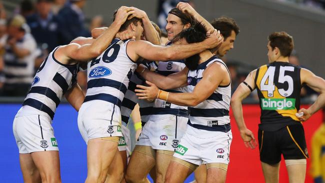 Geelong players celebrate a goal against Richmond.
